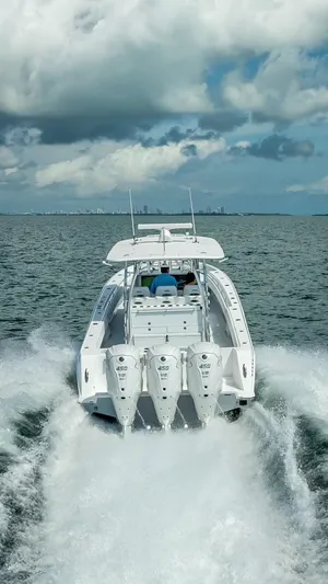  Yacht Photos Pics 2025 Contender 44 ST boat cruising on open water under cloudy skies.