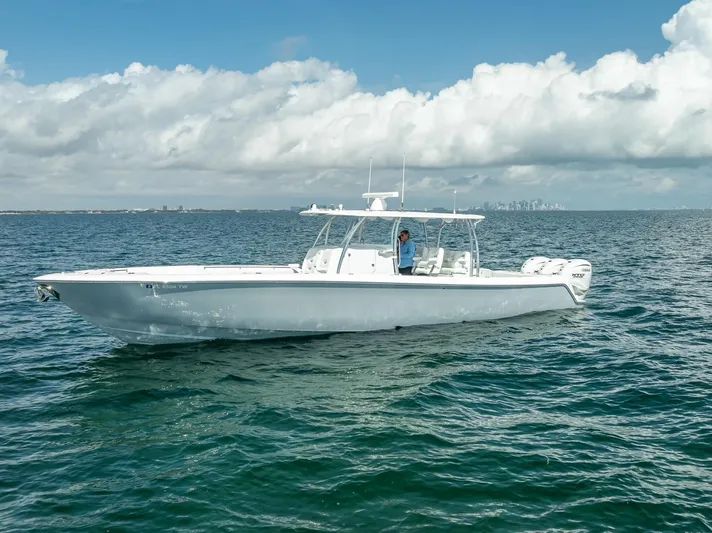  Yacht Photos Pics 2025 Contender 44 ST boat on open water under cloudy sky.