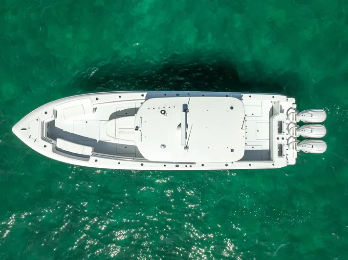  Yacht Photos Pics Aerial view of 2025 Contender 44 ST boat on turquoise water.