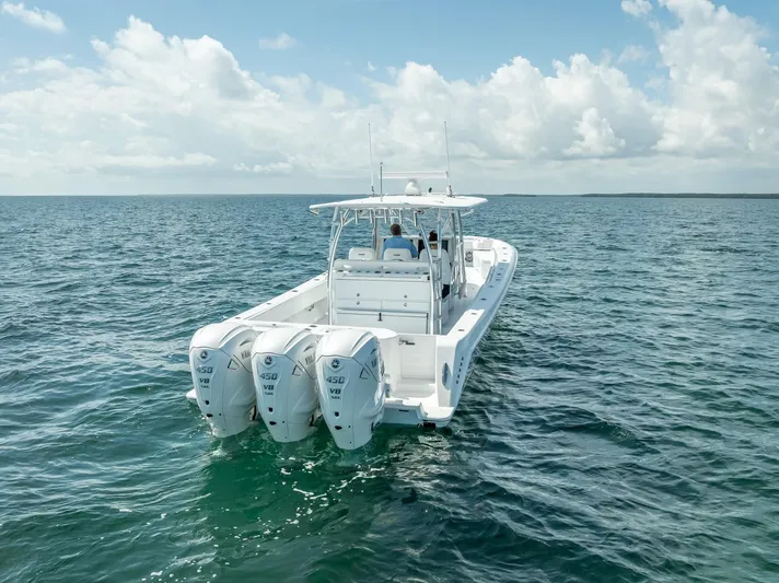  Yacht Photos Pics 2025 Contender 44 ST boat with triple engines cruising on open water.