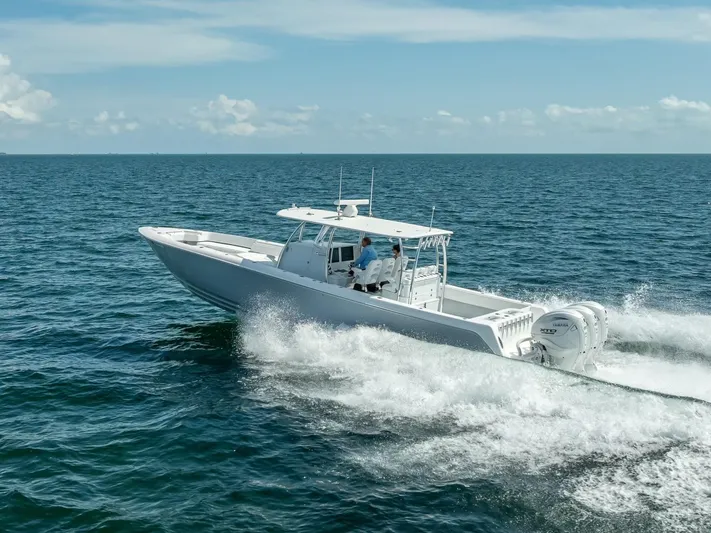  Yacht Photos Pics 2025 Contender 44 ST boat cruising on open ocean waters.