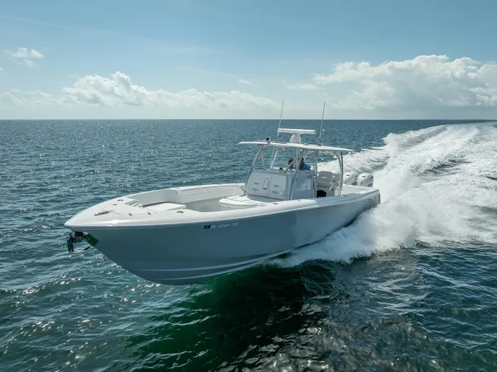  Yacht Photos Pics 2025 Contender 44 ST boat cruising on open ocean waters.