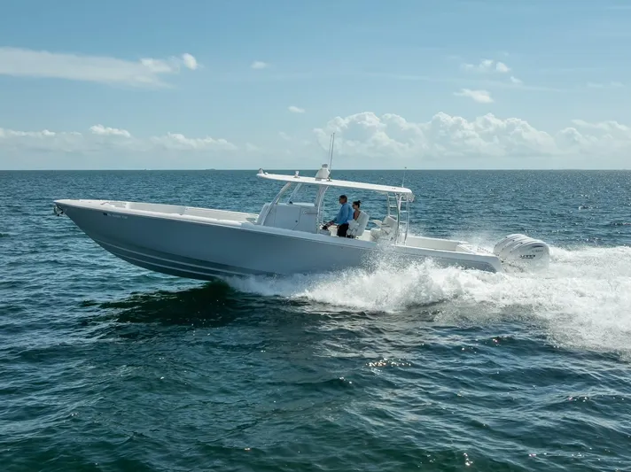  Yacht Photos Pics 2025 Contender 44 ST boat cruising on open water under clear skies.