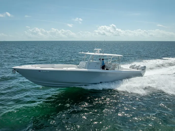  Yacht Photos Pics 2025 Contender 44 ST boat cruising on open ocean waters.