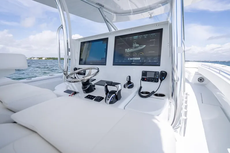  Yacht Photos Pics 2025 Contender 44 ST boat cockpit with advanced navigation screens and controls.
