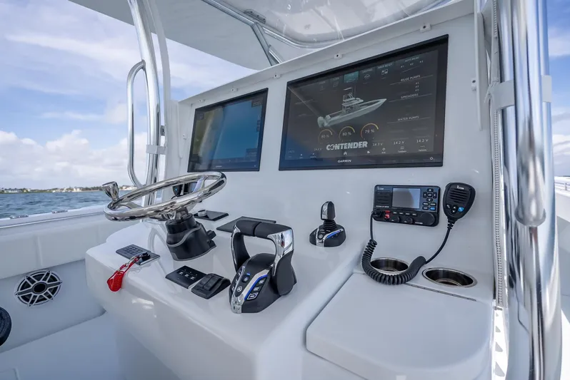  Yacht Photos Pics 2025 Contender 44 ST boat dashboard with dual screens and navigation controls.