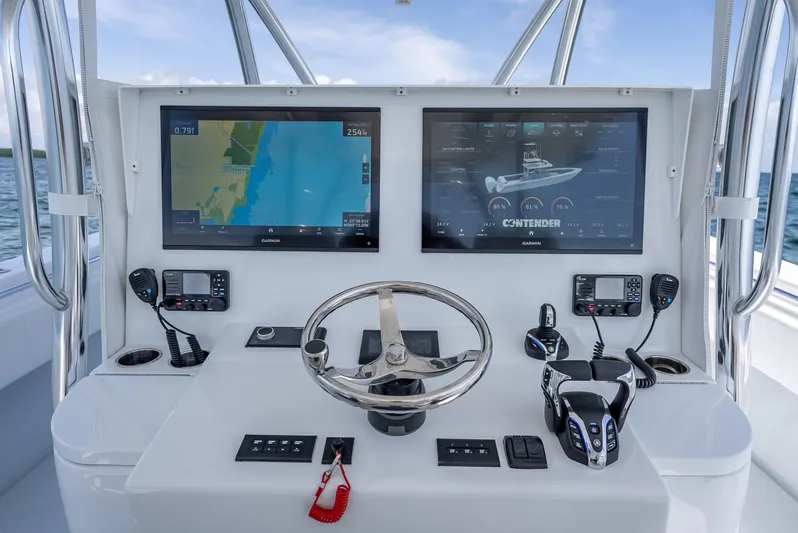  Yacht Photos Pics Helm of 2025 Contender 44 ST boat with dual navigation screens and controls.