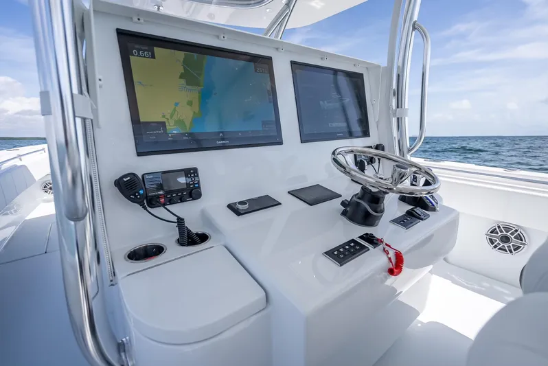  Yacht Photos Pics Helm of 2025 Contender 44 ST boat with dual screens and navigation controls.