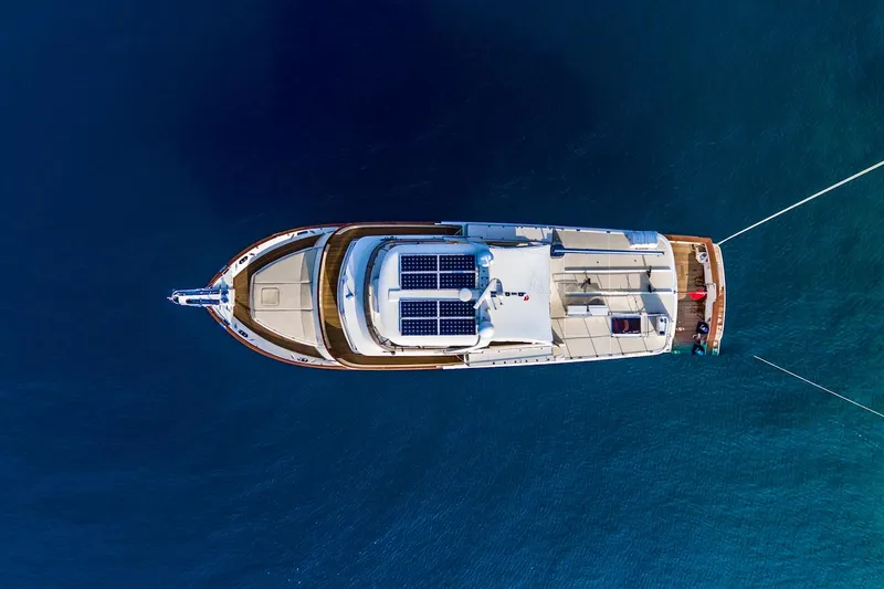 Perseus Yacht Photos Pics Aerial view of 2004 Fleming 75 yacht with solar panels on blue water.