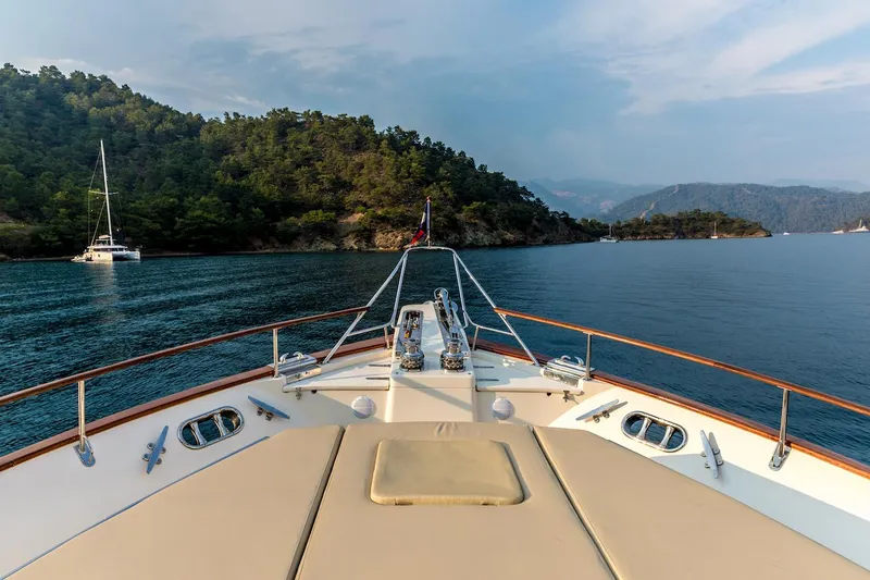 Perseus Yacht Photos Pics Bow view of 2004 Fleming 75 yacht cruising near lush, forested islands.