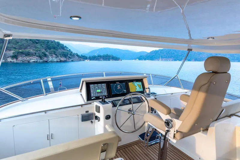 Perseus Yacht Photos Pics Helm of 2004 Fleming 75 yacht with scenic ocean view and modern navigation equipment.