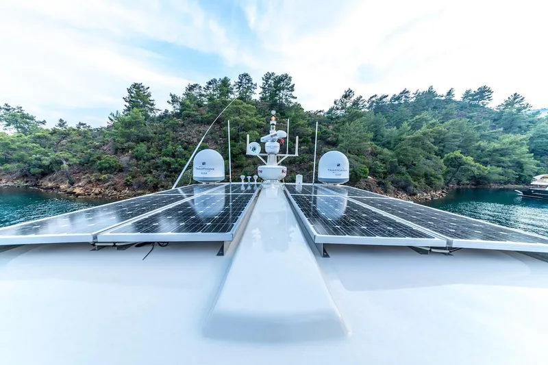 Perseus Yacht Photos Pics Fleming 75 yacht with solar panels, cruising near a forested shoreline, 2004 model.