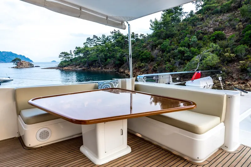 Perseus Yacht Photos Pics Luxury yacht Fleming 75, 2004 model, featuring elegant outdoor seating with scenic ocean view.