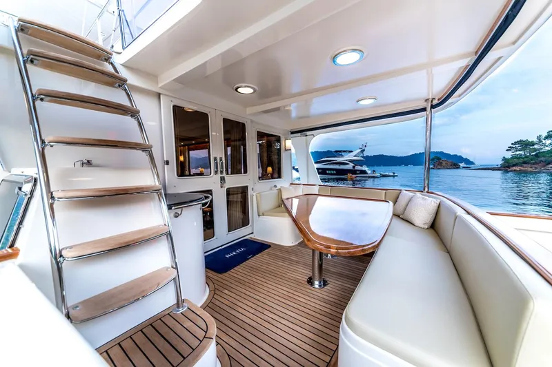 Perseus Yacht Photos Pics Luxurious 2004 Fleming 75 yacht interior with elegant seating and scenic ocean view.