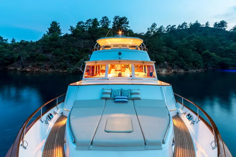 Perseus Yacht Photos Pics Luxurious 2004 Fleming 75 yacht anchored in serene waters at dusk.