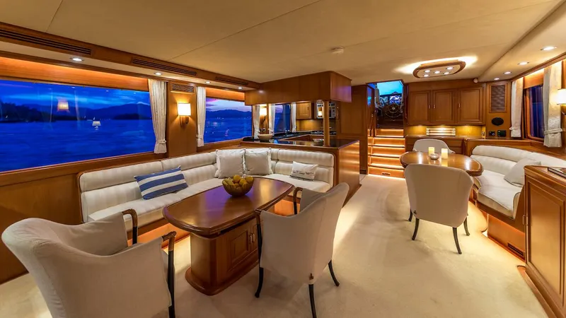 Perseus Yacht Photos Pics Luxurious interior of 2004 Fleming 75 yacht with elegant seating and dining area.