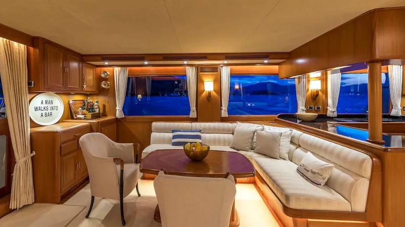 Perseus Yacht Photos Pics Luxurious interior of a 2004 Fleming 75 yacht with elegant seating and ambient lighting.