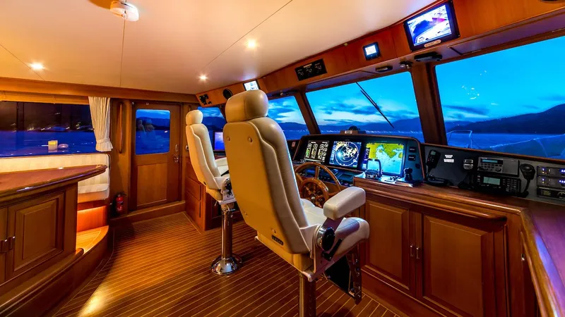 Perseus Yacht Photos Pics Luxurious 2004 Fleming 75 yacht interior with modern navigation equipment and elegant wood finishes.
