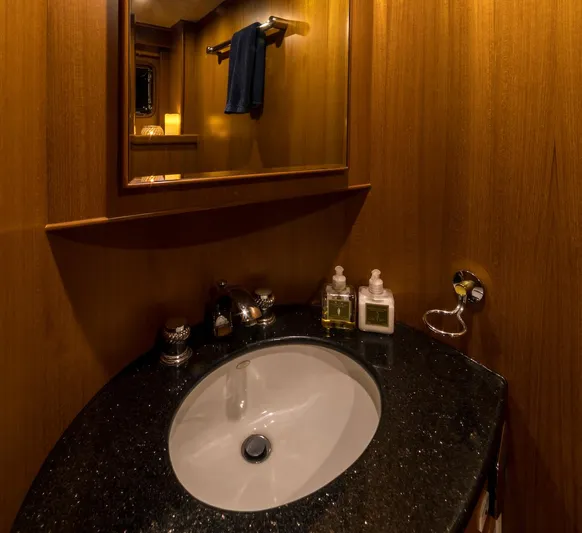 Perseus Yacht Photos Pics Luxurious bathroom vanity with black countertop in 2004 Fleming 75 yacht.