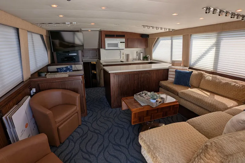 Mas Fina Yacht Photos Pics Luxurious interior of a 1987 Hatteras Convertible yacht with cozy seating and modern amenities.