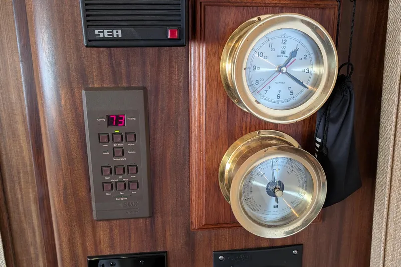 Mas Fina Yacht Photos Pics 1987 Hatteras Convertible yacht interior with brass instruments and digital control panel.