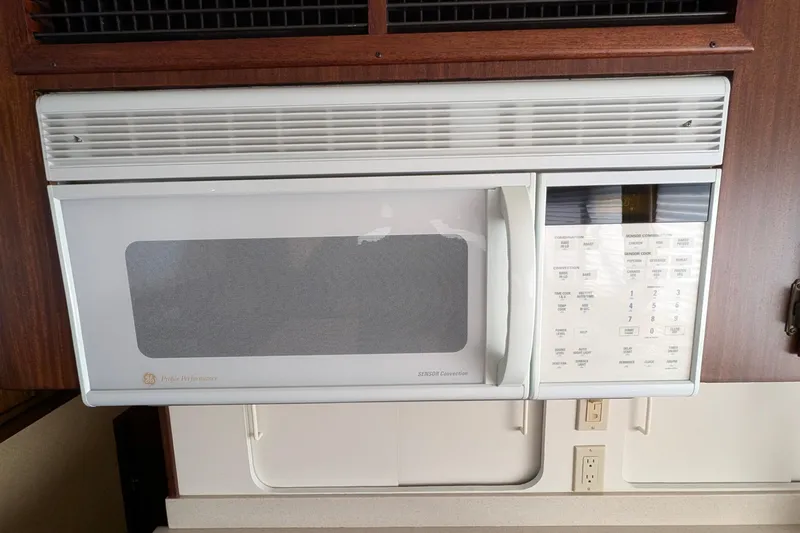 Mas Fina Yacht Photos Pics Built-in microwave in 1987 Hatteras Convertible yacht kitchen.