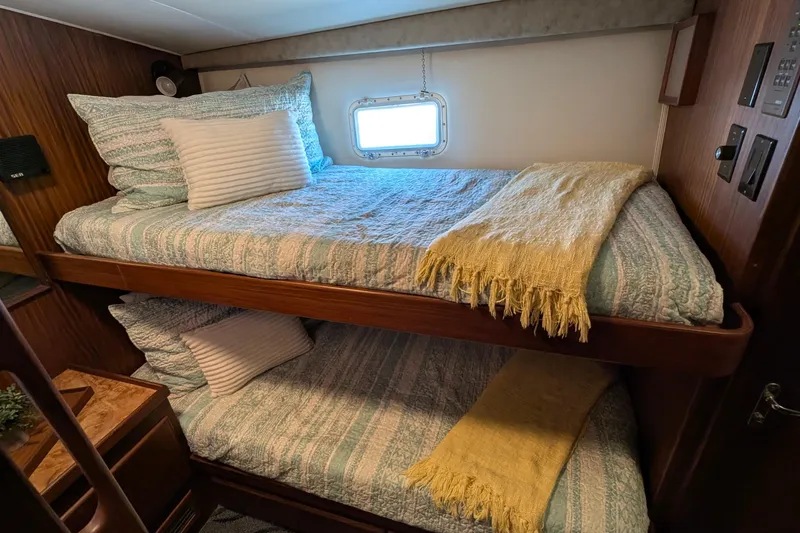 Mas Fina Yacht Photos Pics Cozy 1987 Hatteras Convertible yacht cabin with bunk beds and nautical decor.