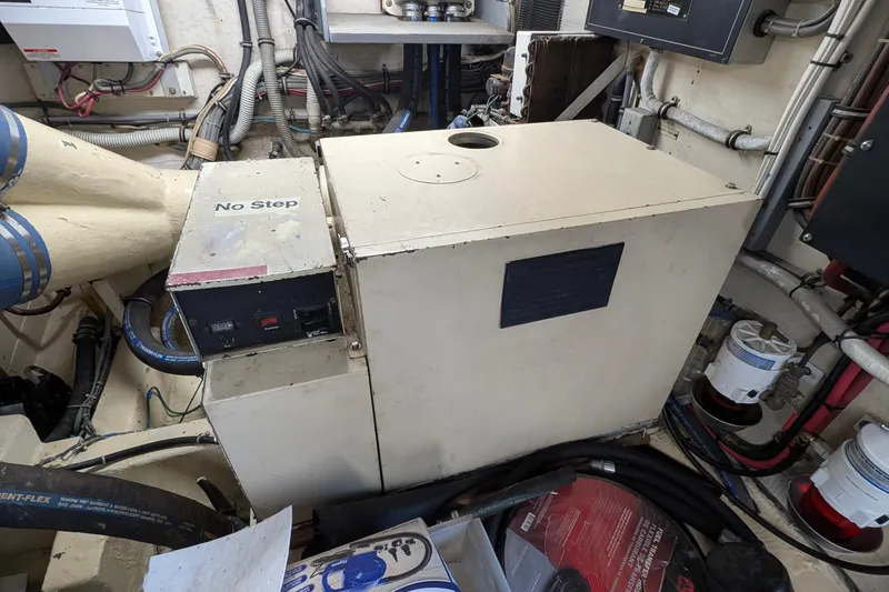 Mas Fina Yacht Photos Pics Engine room of 1987 Hatteras Convertible boat with machinery and wiring.