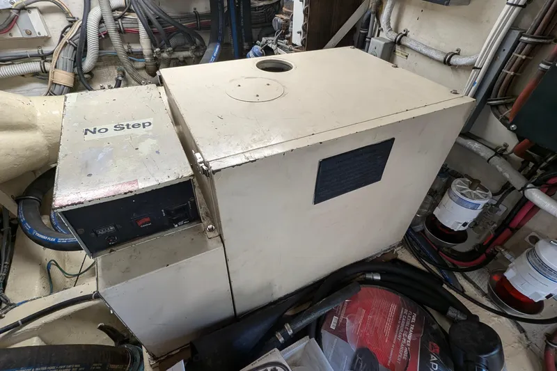 Mas Fina Yacht Photos Pics Engine room of 1987 Hatteras Convertible boat with machinery and equipment.