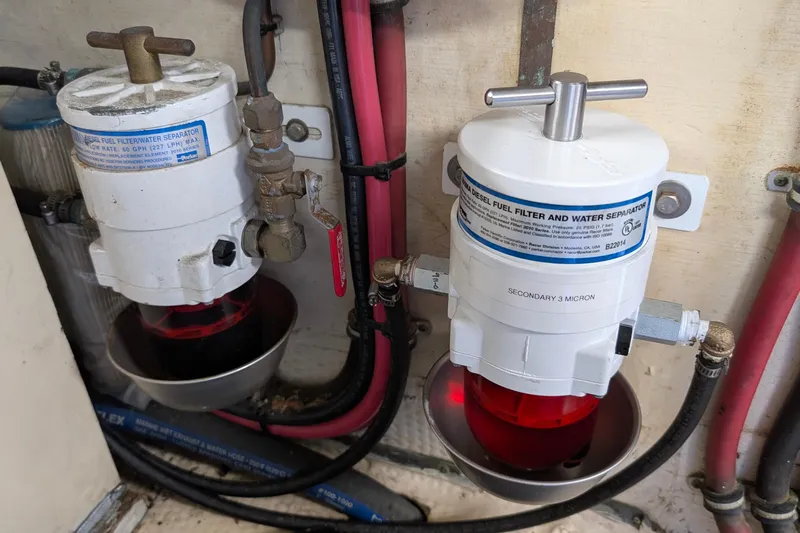 Mas Fina Yacht Photos Pics 1987 Hatteras Convertible diesel fuel filter and water separator system in engine room.