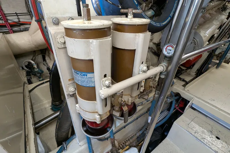 Mas Fina Yacht Photos Pics Engine room of 1987 Hatteras Convertible boat showing dual Racor fuel filters.