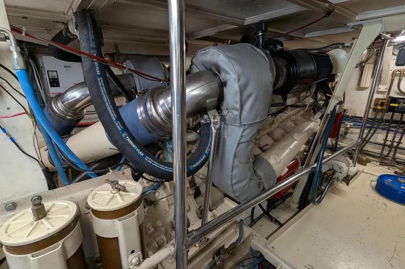 Mas Fina Yacht Photos Pics Engine room of a 1987 Hatteras Convertible yacht, showcasing detailed machinery and components.