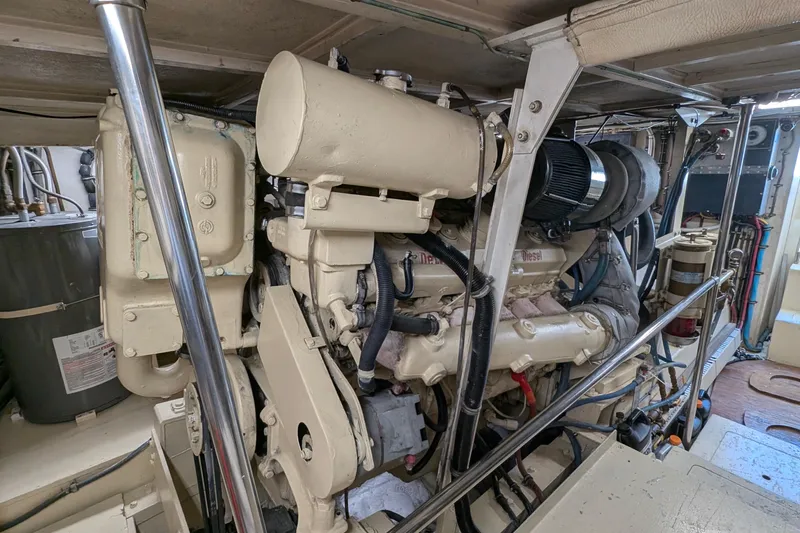 Mas Fina Yacht Photos Pics Engine room of a 1987 Hatteras Convertible yacht, showcasing detailed machinery.