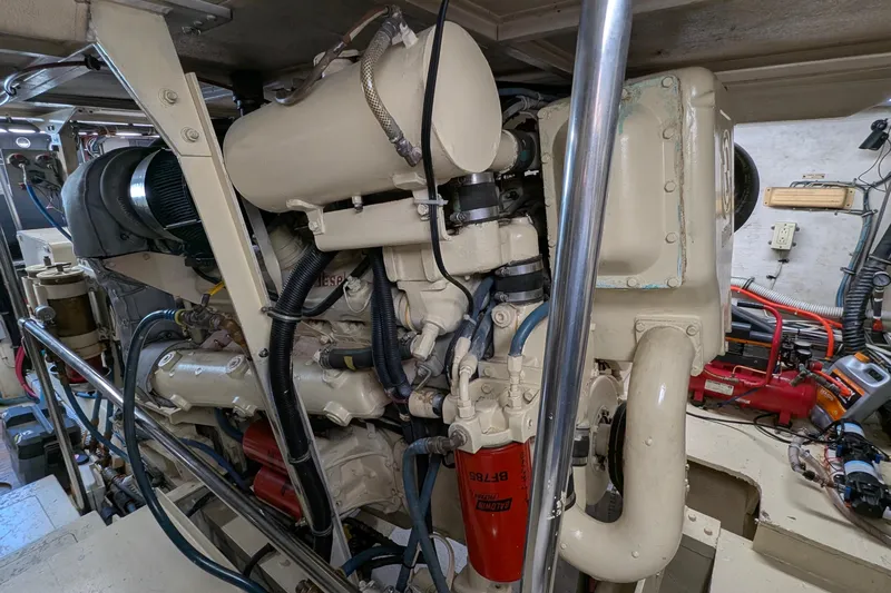 Mas Fina Yacht Photos Pics Engine room of a 1987 Hatteras Convertible boat, showcasing detailed machinery.