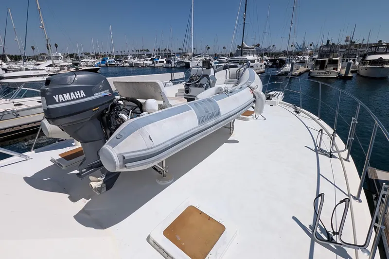 Mas Fina Yacht Photos Pics 1987 Hatteras Convertible yacht with Yamaha outboard motor and inflatable boat on deck.
