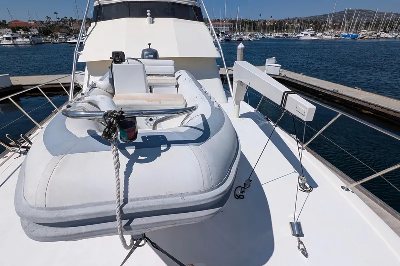 Mas Fina Yacht Photos Pics 1987 Hatteras Convertible yacht with inflatable boat on deck, docked at marina.