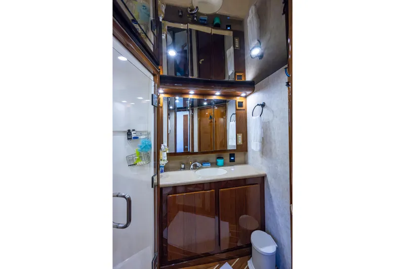 Miss Elena*eous Yacht Photos Pics Luxurious bathroom in 2004 Egg Harbor 43 Sport Fisherman yacht, featuring elegant wood cabinetry.