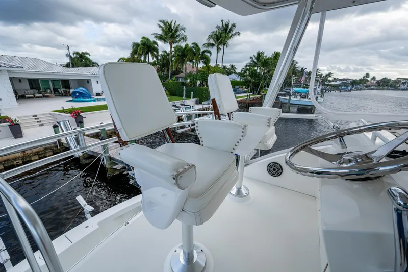 Miss Elena*eous Yacht Photos Pics 2004 Egg Harbor 43 Sport Fisherman helm with white captain chairs and waterfront view.