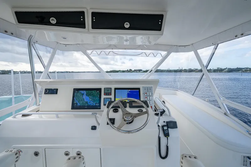 Miss Elena*eous Yacht Photos Pics Helm of 2004 Egg Harbor 43 Sport Fisherman with navigation screens and steering wheel.