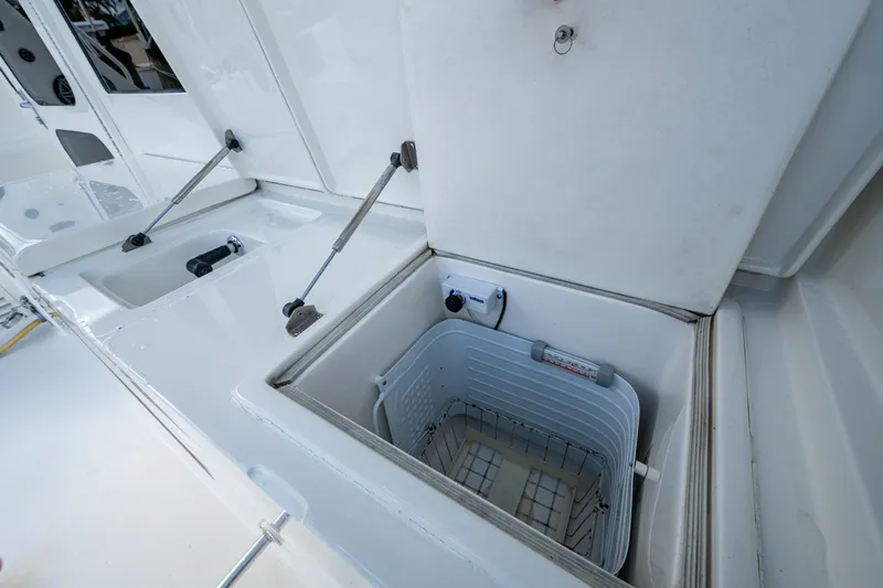 Miss Elena*eous Yacht Photos Pics Open storage compartment on 2004 Egg Harbor 43 Sport Fisherman boat deck.