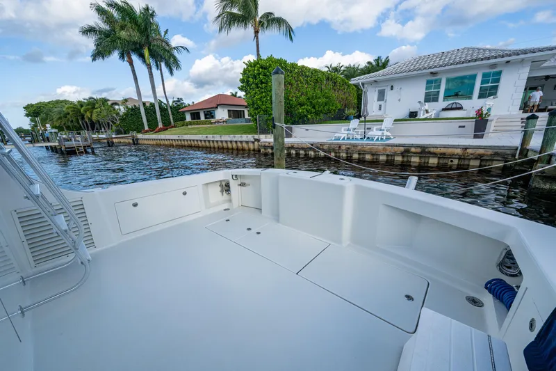 Miss Elena*eous Yacht Photos Pics 2004 Egg Harbor 43 Sport Fisherman boat docked near waterfront homes and palm trees.