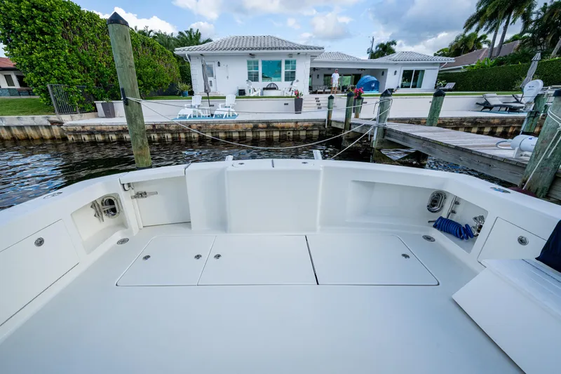 Miss Elena*eous Yacht Photos Pics 2004 Egg Harbor 43 Sport Fisherman boat docked near waterfront home.