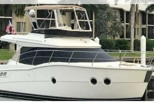 Boundless Yacht Photos Pics 2013 Carver C34 Command Bridge yacht docked near waterfront buildings.