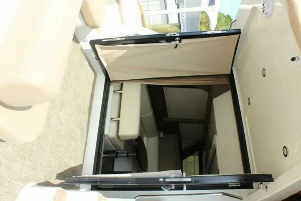 Boundless Yacht Photos Pics 2013 Carver C34 Command Bridge interior with beige seating and open cabin door.