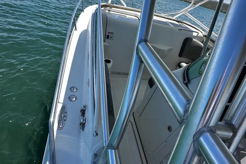  Yacht Photos Pics 2006 Hydra-Sports Vector 3300 VX boat deck with railing, on calm water.