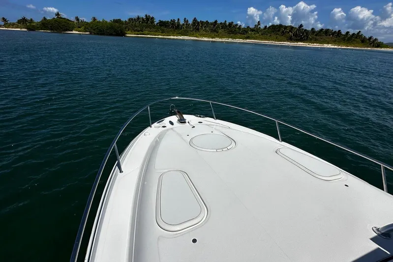  Yacht Photos Pics 2006 Hydra-Sports Vector 3300 VX boat cruising near a tropical island.
