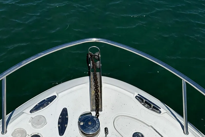  Yacht Photos Pics Bow of 2006 Hydra-Sports Vector 3300 VX boat with anchor chain over water.