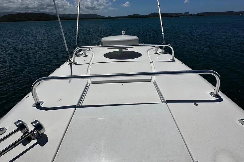  Yacht Photos Pics 2006 Hydra-Sports Vector 3300 VX boat deck on calm water, clear sky background.