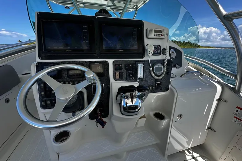  Yacht Photos Pics 2006 Hydra-Sports Vector 3300 VX boat cockpit with steering wheel and navigation controls.