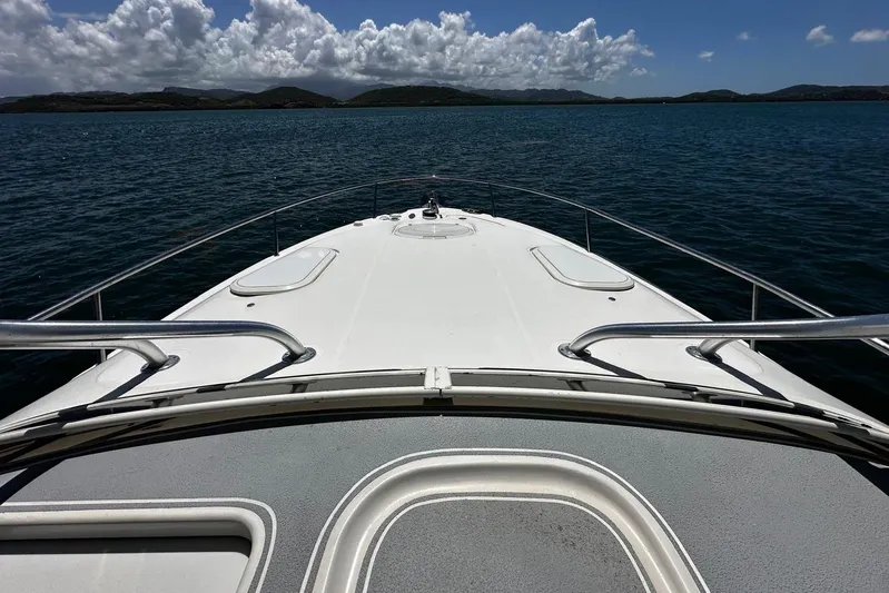  Yacht Photos Pics 2006 Hydra-Sports Vector 3300 VX boat on calm water under cloudy sky.